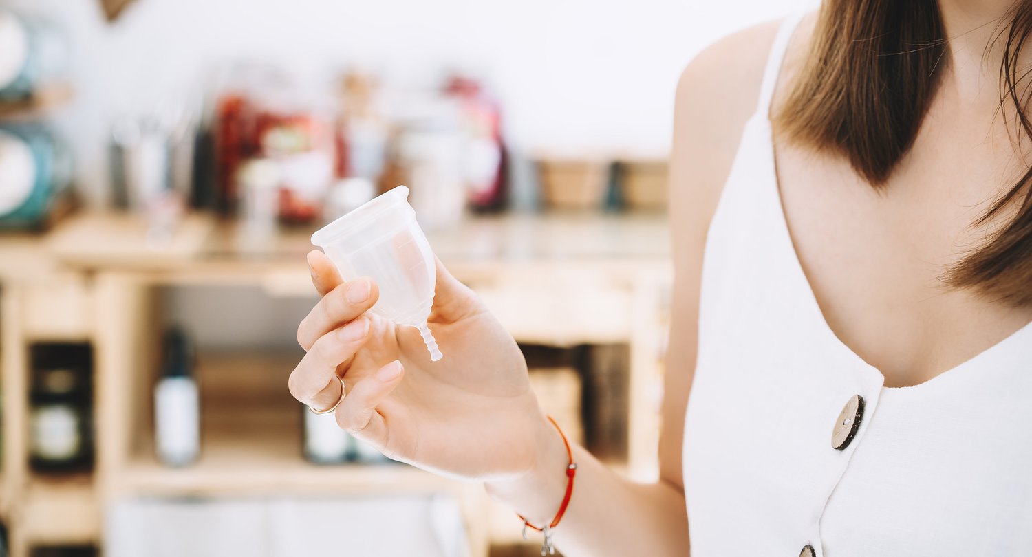 woman holding menstrual cup