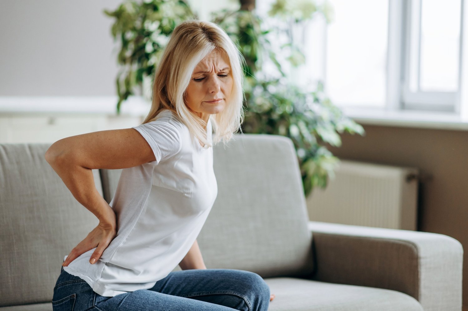 Woman holding back in pain