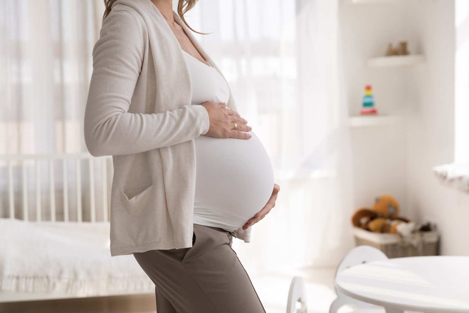 Pregnant woman holding tummy